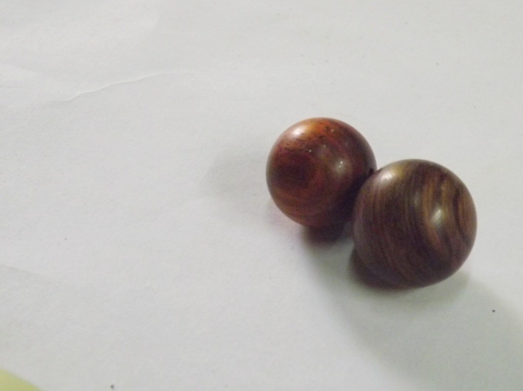 Two beads for bracelets, made of Chinese Yew (left) and Nanmu (right)