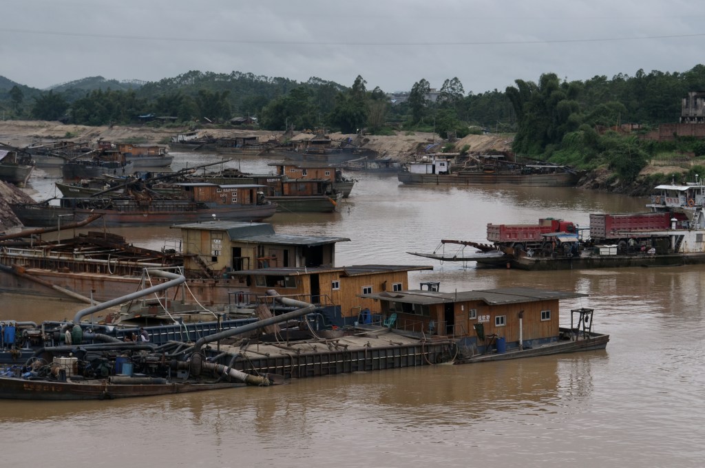 While huge multilane highways famously stand empty in the northern provinces, roads connecting more rural towns are often incomplete. They revert to dirt roads in the blink of an eye and bridges wash out, forcing trucks to ferry across rivers like this one.